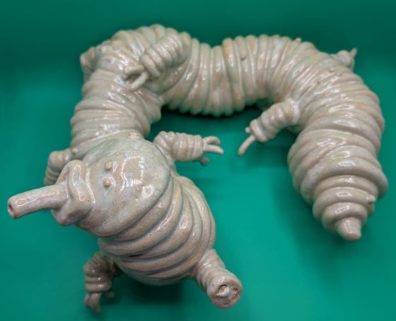 Ceramic sculpture - wider shot of pale centipede like creature with proboscis