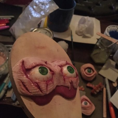 A pair of polymer clay eyes and flesh in the shape of a sleep-mask