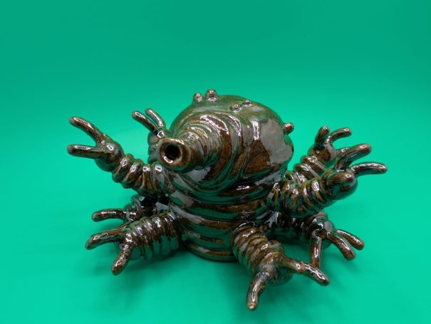 A small shiny standing tardigrade, eight arms outstretched
