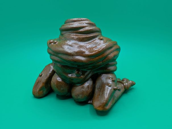 Ceramic sculpture - a squishy faceless frog-like creature with no face and a big butt