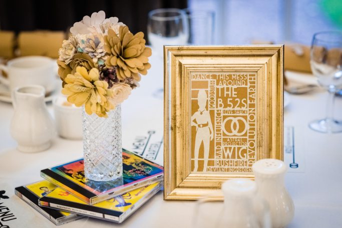 A paper cut B-52s design in a gold frame