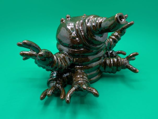 A small shiny standing tardigrade, eight arms outstretched