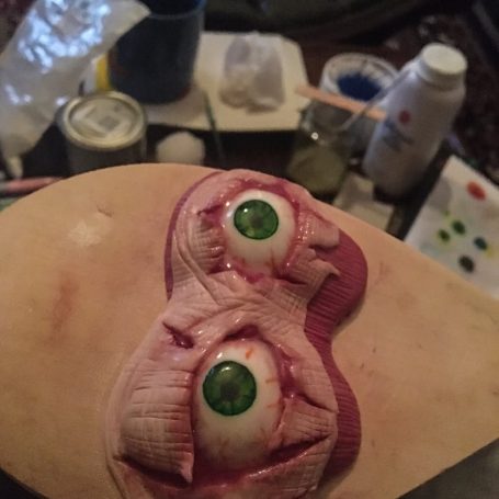 A pair of polymer clay eyes and flesh in the shape of a sleep-mask