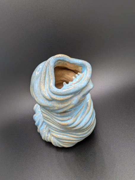 Ceramic sculpture - An eyeless thin coiled worm creature wailing with a large open toothy mouth
