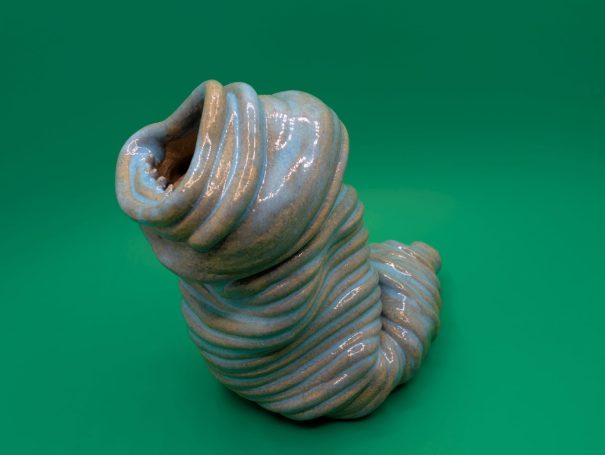 Ceramic sculpture - An eyeless thin coiled worm creature wailing with a large open toothy mouth