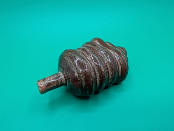 Ceramic sculpture - A single ox-blood coloured 'worm' creature with proboscis