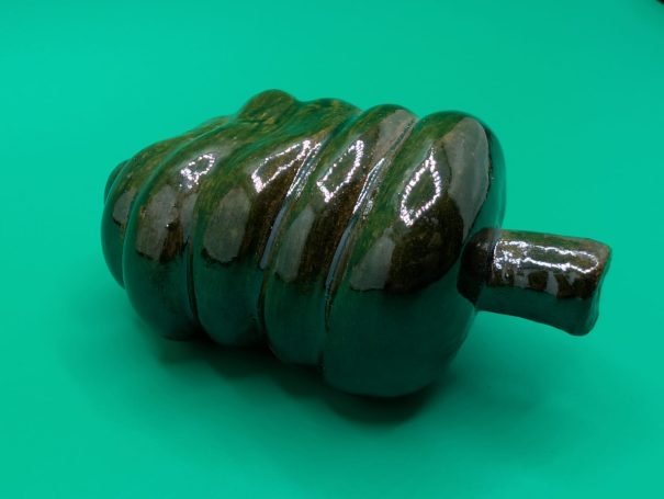 Ceramic sculpture - A single shiny green coloured 'worm' creature with proboscis