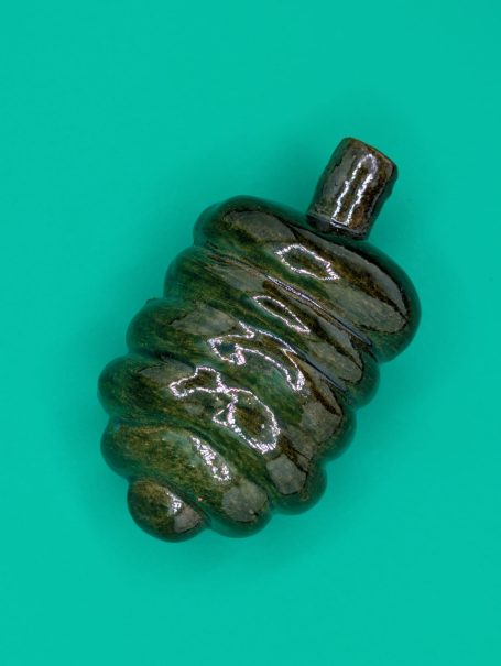 Ceramic sculpture - A single shiny green coloured 'worm' creature with proboscis