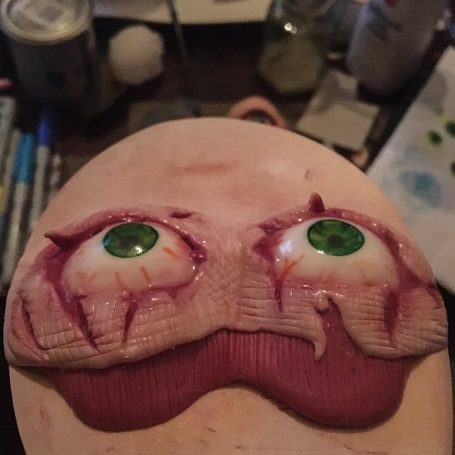 A pair of polymer clay eyes and flesh in the shape of a sleep-mask