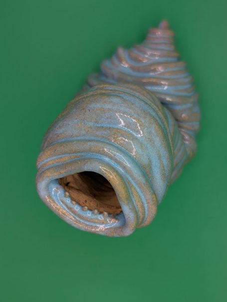 Ceramic sculpture - An eyeless thin coiled worm creature wailing with a large open toothy mouth