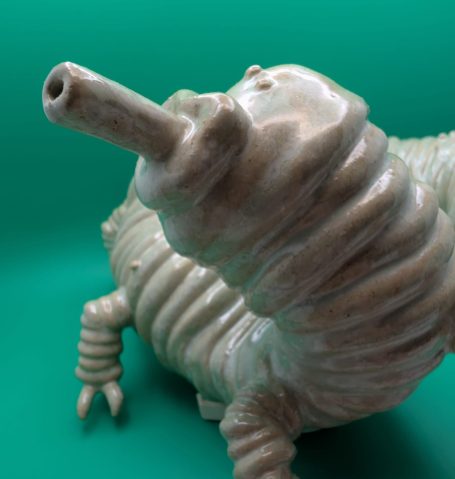 Ceramic sculpture - close up of face and front legs of pale centipede like creature with proboscis