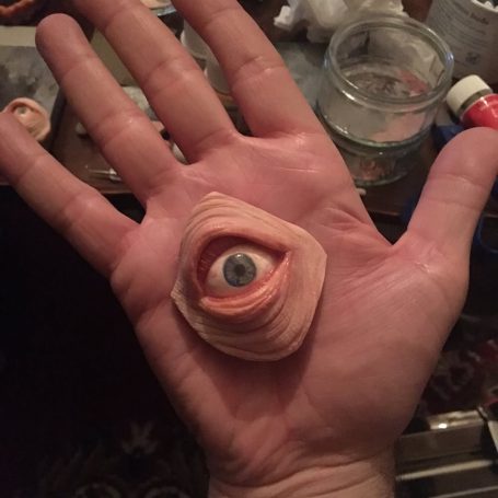 Polymer clay eye held in a person's hand