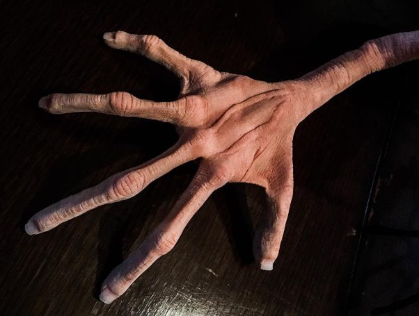 A polymer clay hand with long thing fingers
