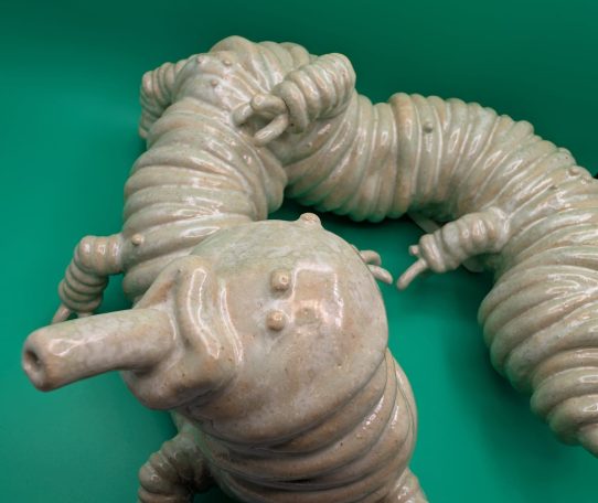 Ceramic sculpture - close up of face and front legs of pale centipede like creature with proboscis