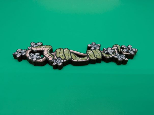 A wooden charm of a snake on a flowering branch