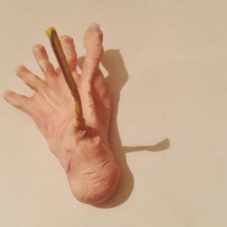 A polymer clay foot with splayed toes
