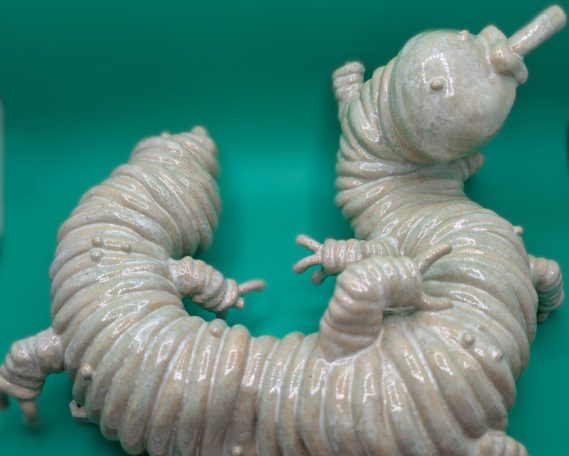 Ceramic sculpture - wider shot of pale centipede like creature with proboscis