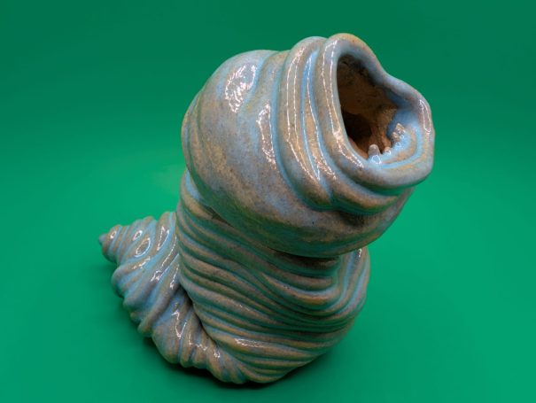 Ceramic sculpture - An eyeless thin coiled worm creature wailing with a large open toothy mouth