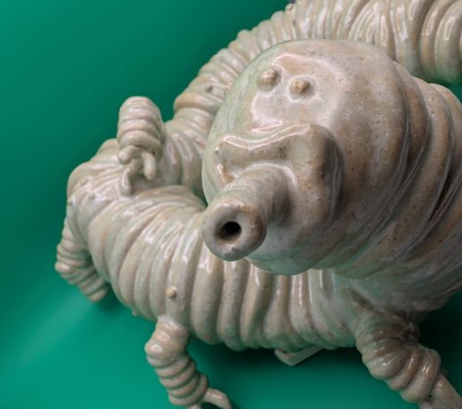 Ceramic sculpture - close up of face and front legs of pale centipede like creature with proboscis