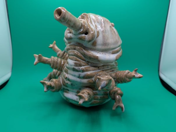 A large standing tardigrade, eight arms outstretched.  It's body made of distorted coils