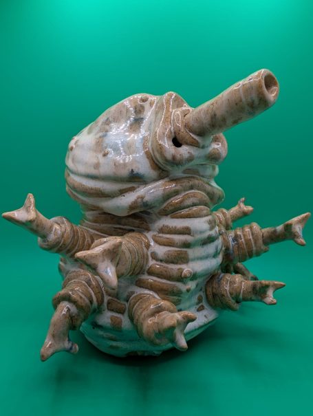 A large standing tardigrade, eight arms outstretched.  It's body made of distorted coils